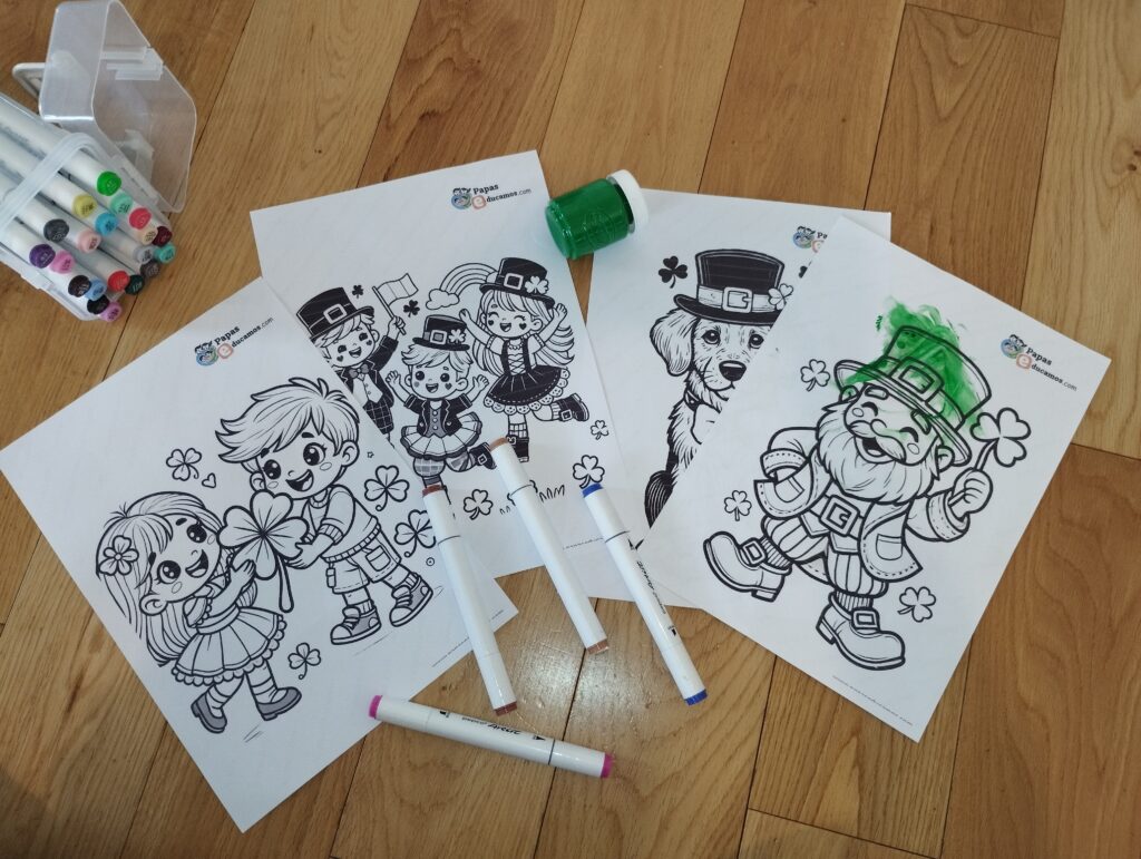 Hojas de dibujos para colorear de St. Patrick’s Day con imágenes de duendes, tréboles y niños celebrando. Incluye rotuladores y pintura de dedos verde sobre un dibujo parcialmente coloreado.